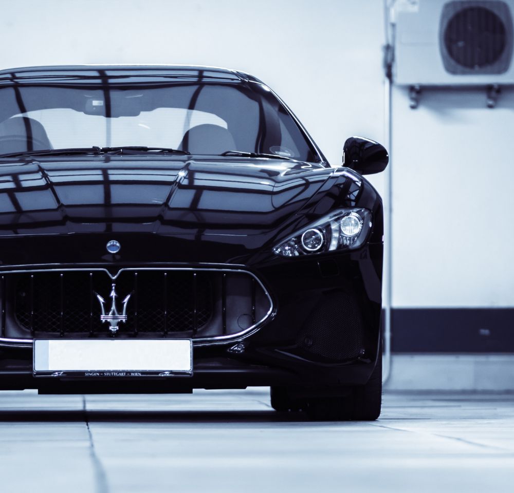 Black Maserati parked in car