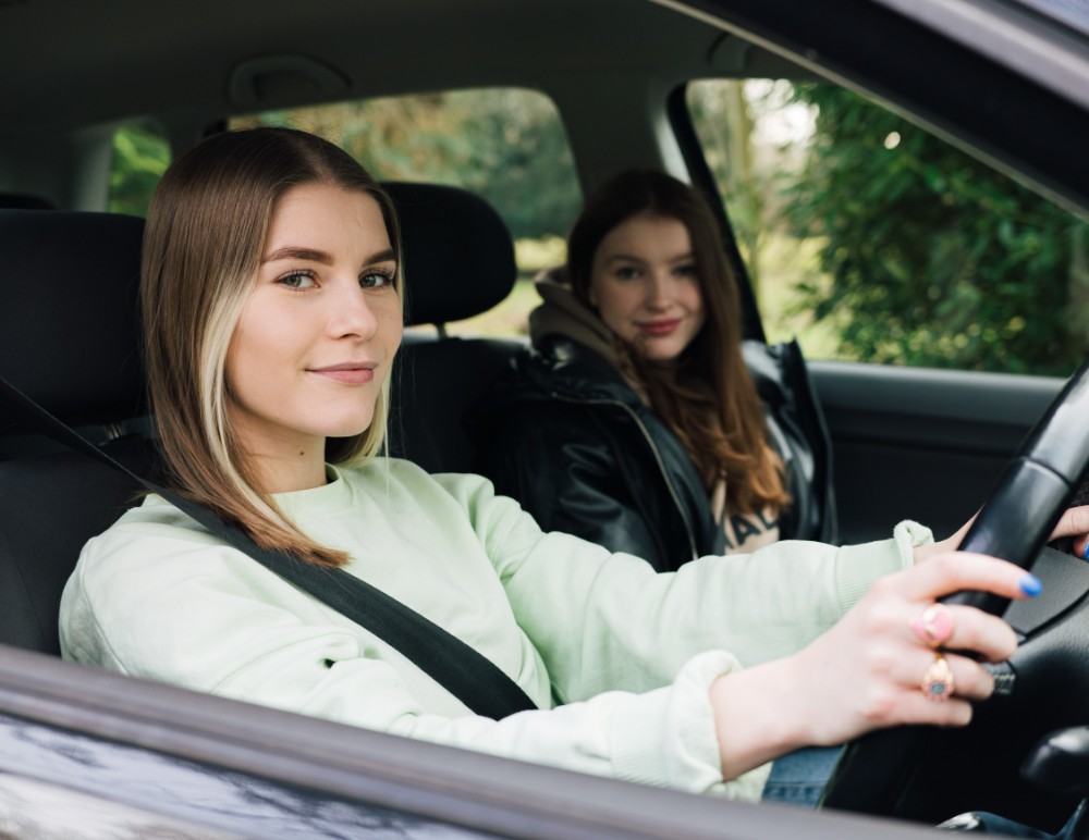 Young drivers sitting in car