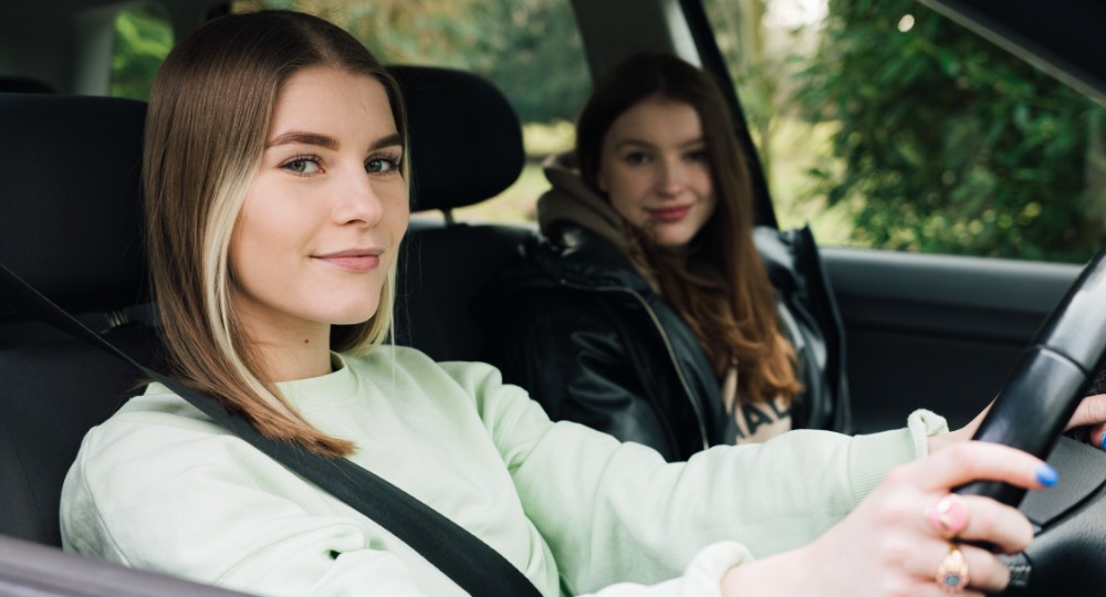 Young drivers sitting in car