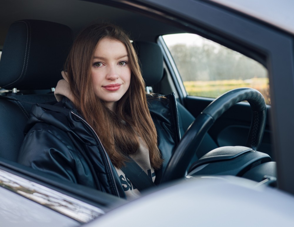 Young driver sitting in driver's seat