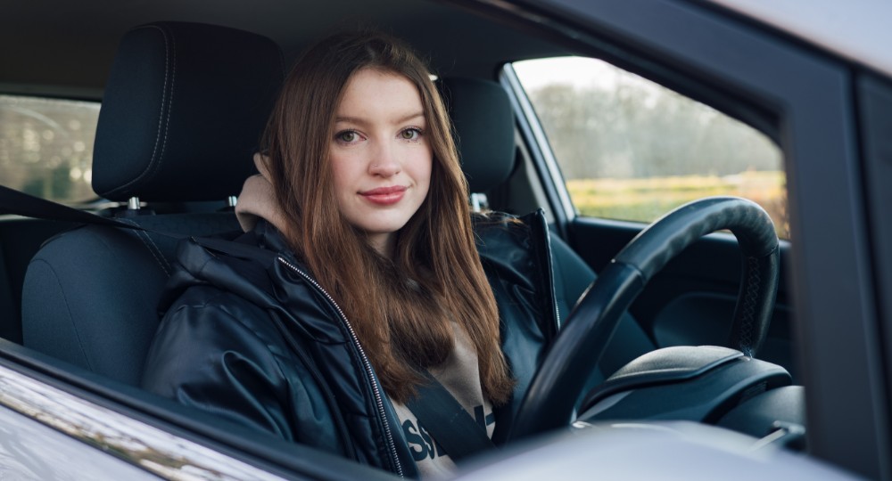 Young driver sitting in driver's seat