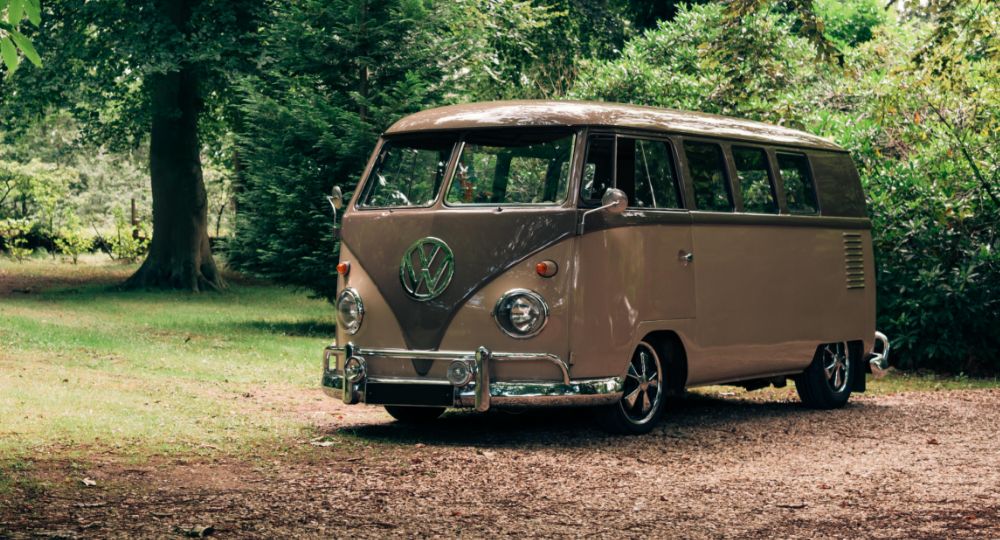 VW camper parked in green area
