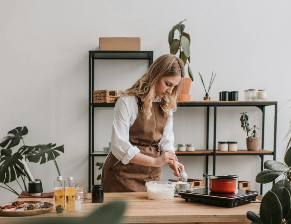 Woman wearing an apron making candles
