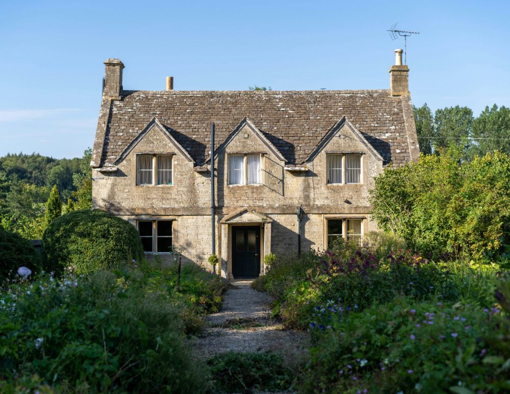 Old period property on summers day with lush green gardens