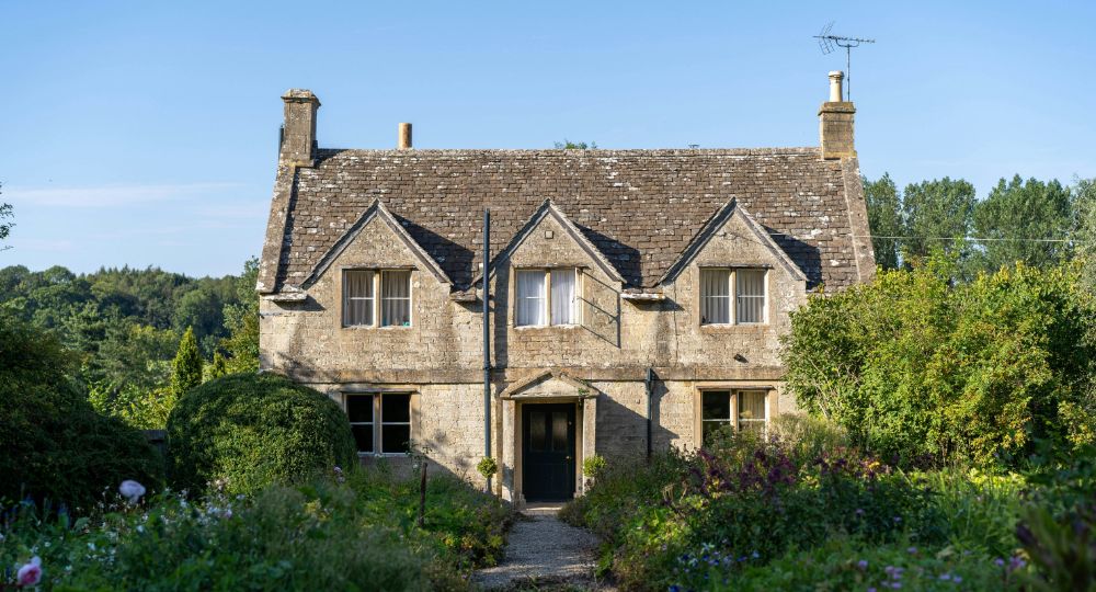 Old period property on summers day with lush green gardens