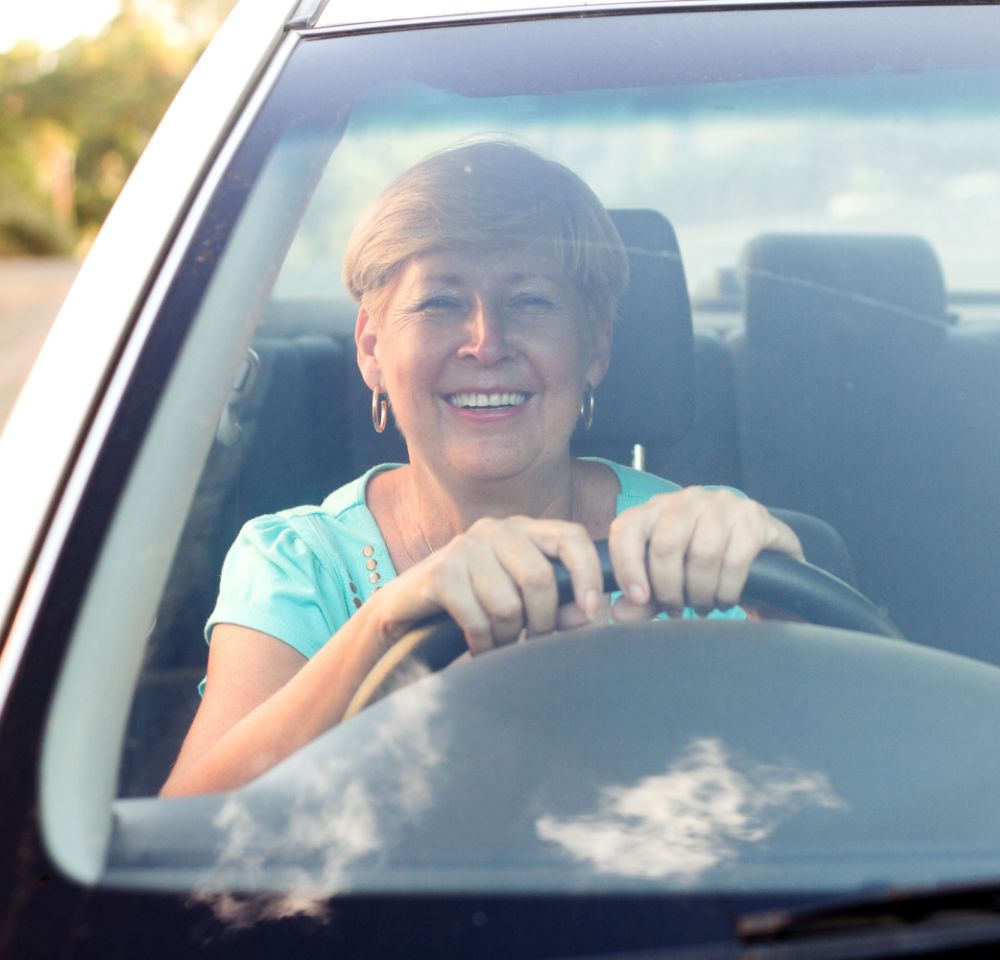 smiling senior lady driving