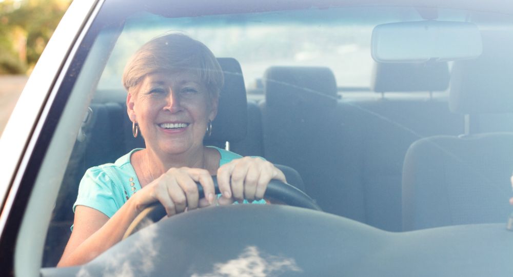 smiling senior lady driving