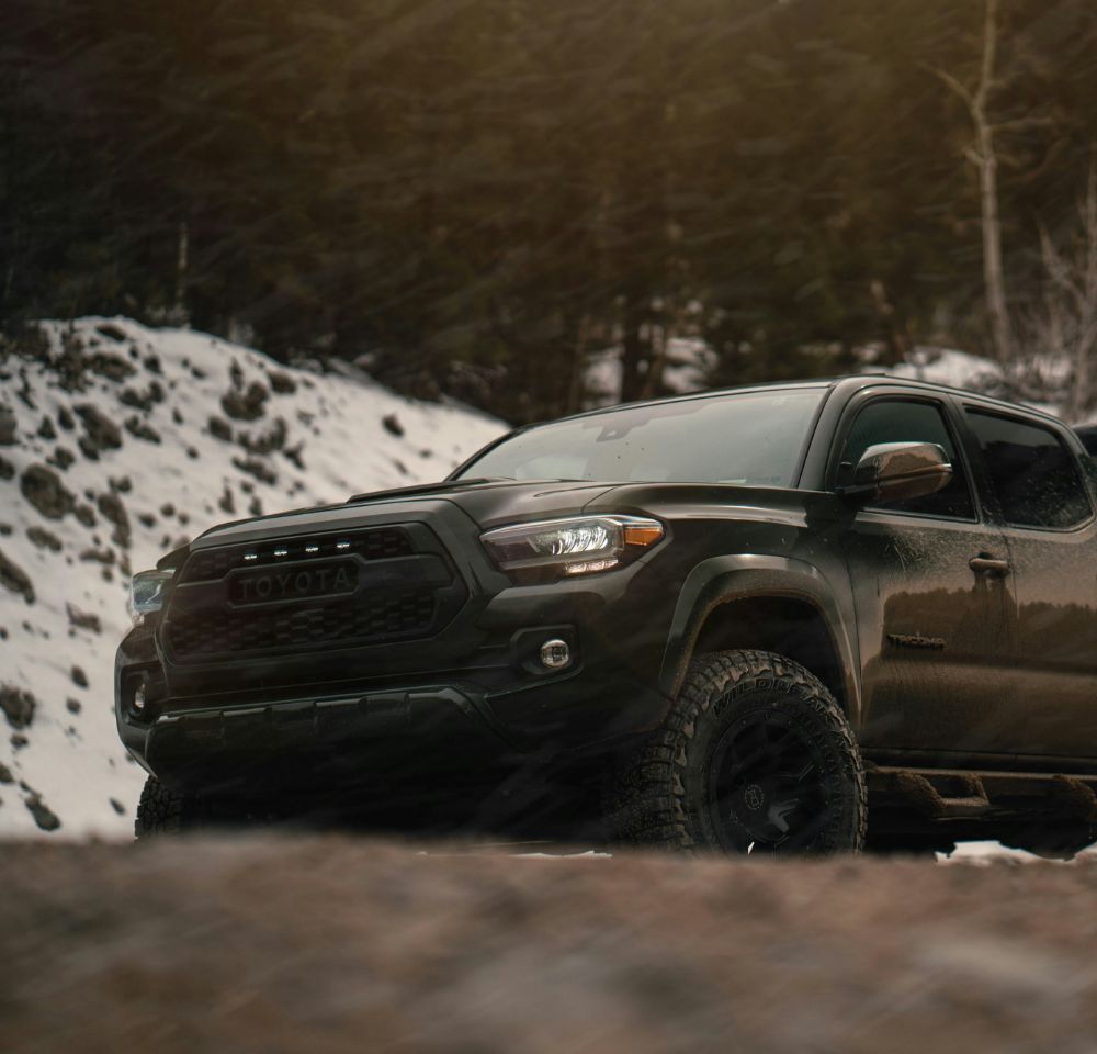 pick up truck driving on snowy road