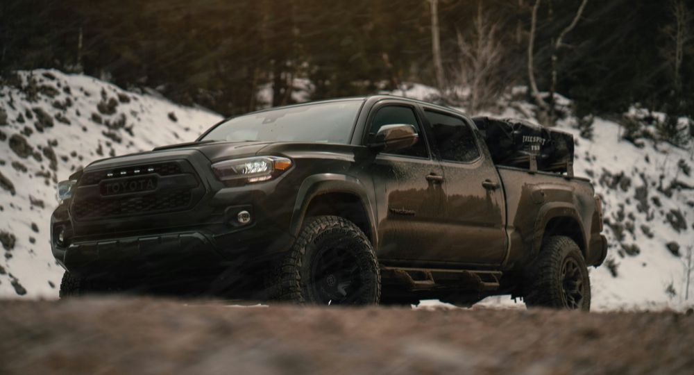 pick up truck driving on snowy road