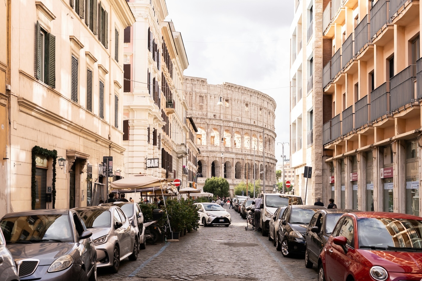 Cars parked next to the Colosseum