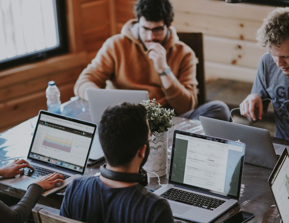Students with laptops around table