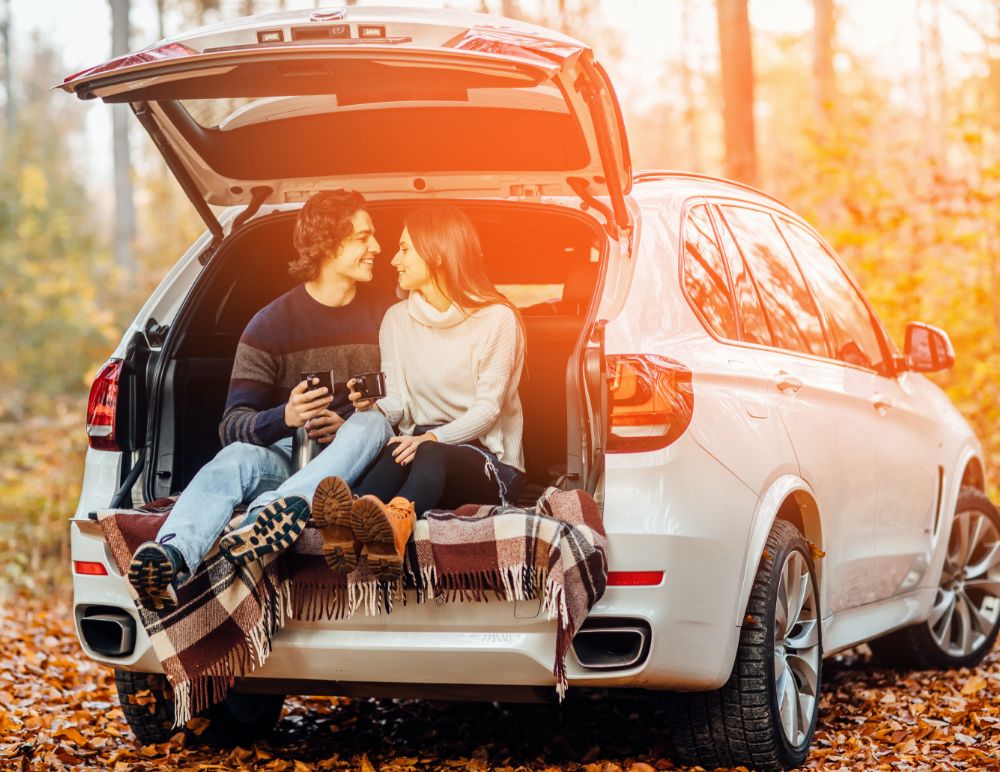 Couple sitting at the back of BMW