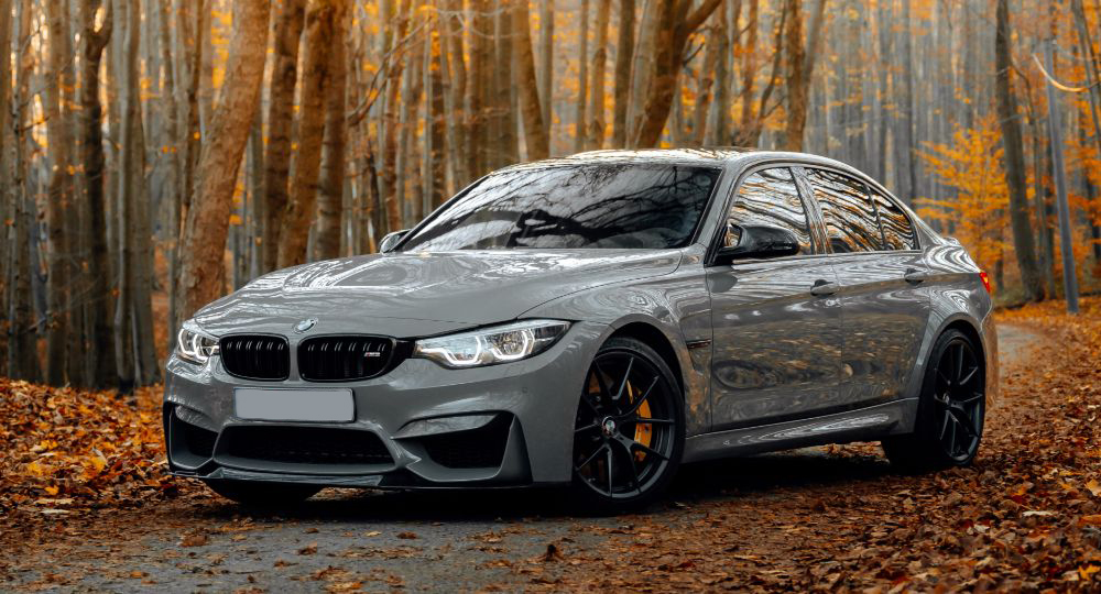 BMW M3 parked outside with trees in the background