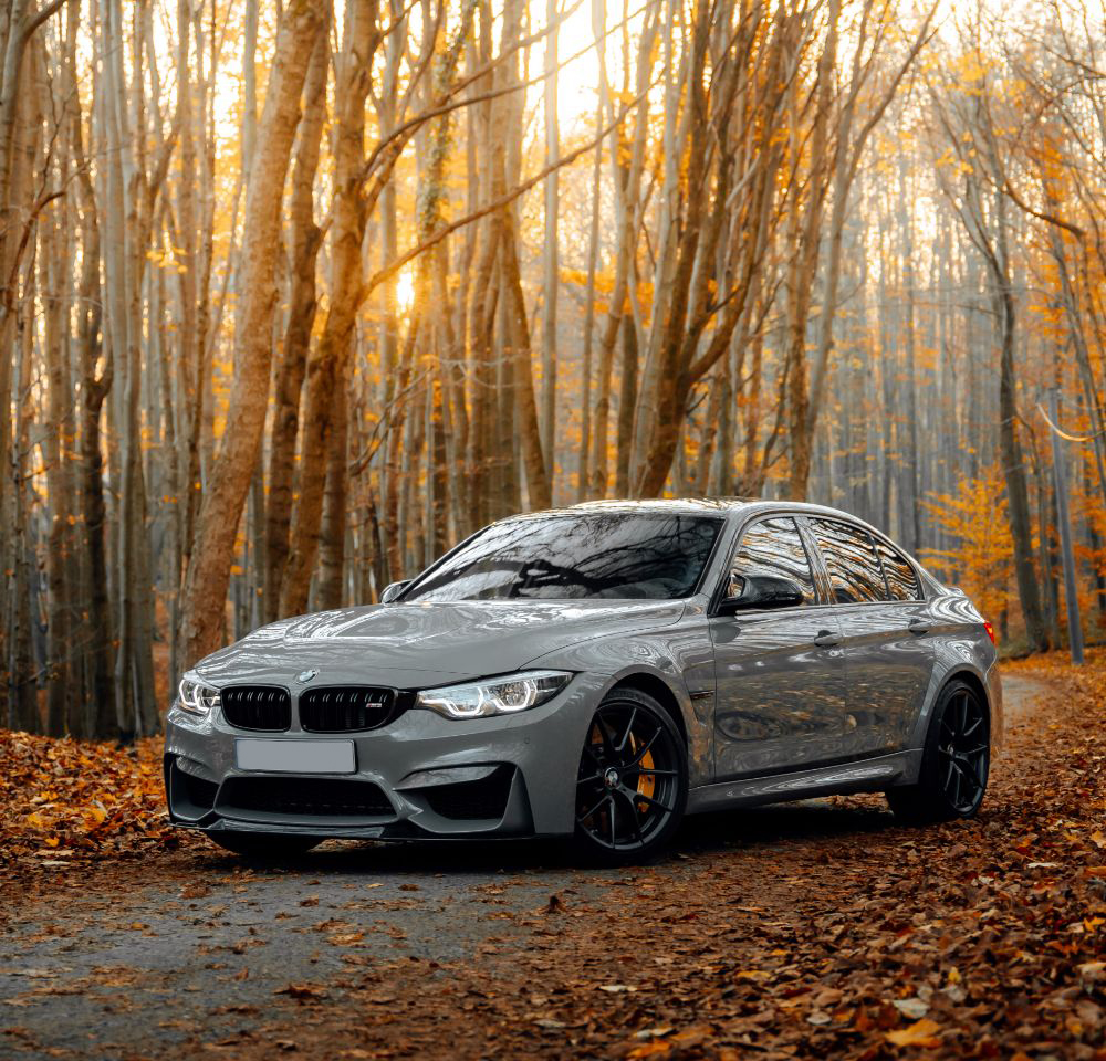 BMW M3 parked outside with trees in the background