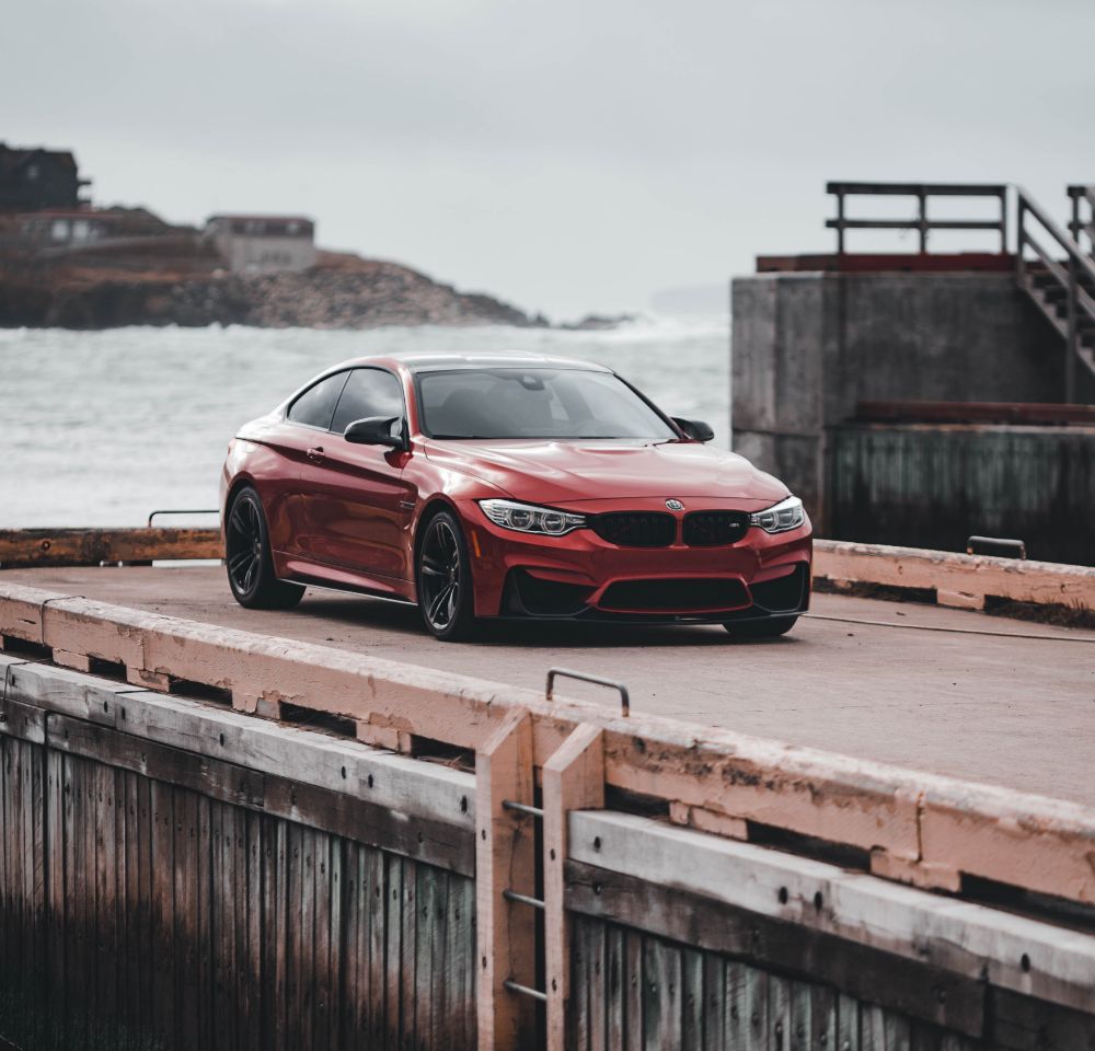 The BMW M3 parked in front of the ocean