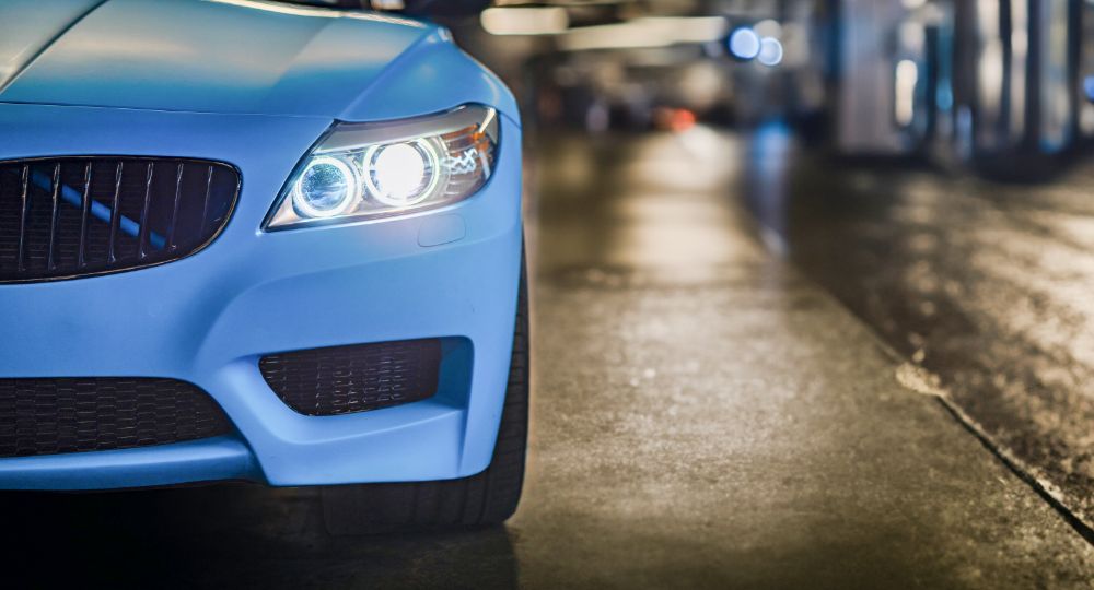 Blue BMW Z4 with headlights on