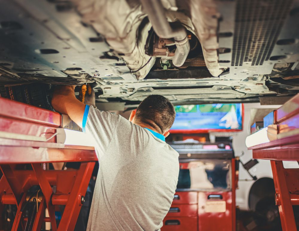 Man Fixing a car on a ramp