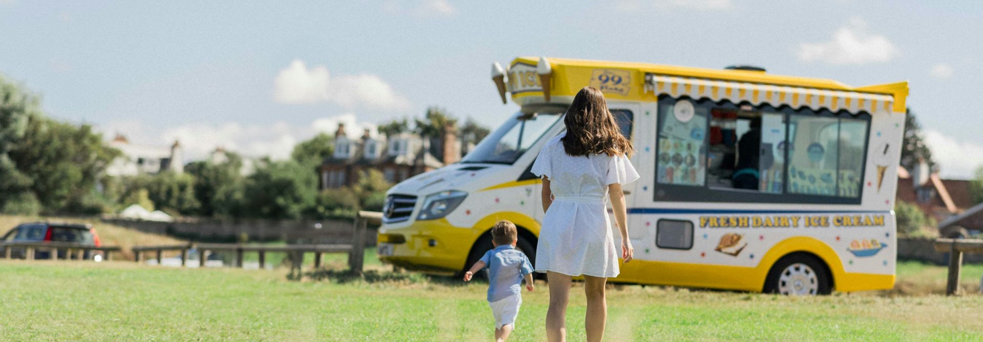 child and mother running over to an ice cream truck