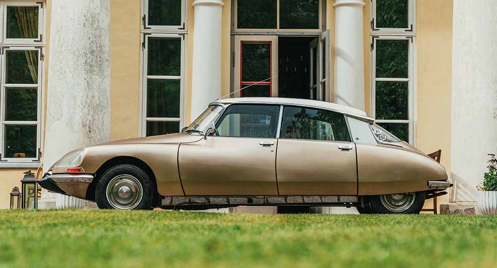 Chrome Citroen DS pictured with building in the background