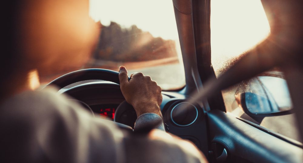 Person with hands on steering wheel