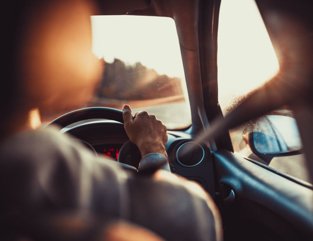 Person with hands on steering wheel
