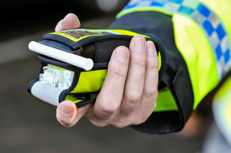 Police officer with breathalyser in hand