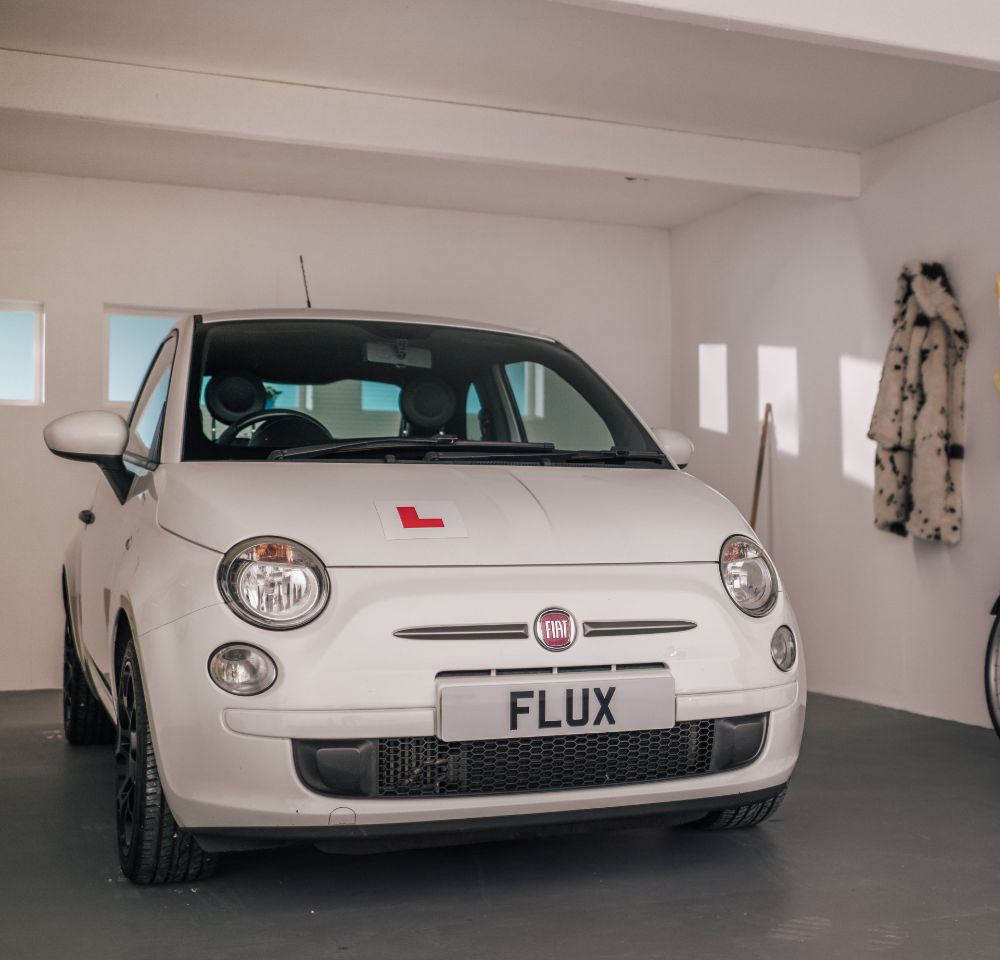 White Fiat 500 parked in garage