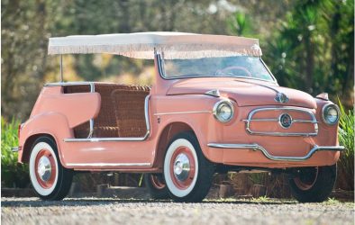 Pink Fiat 600 Jolly parked on gravel