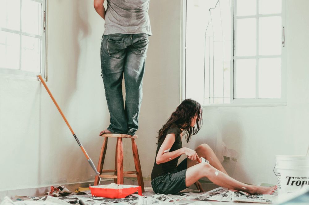 Couple renovating and painting a room