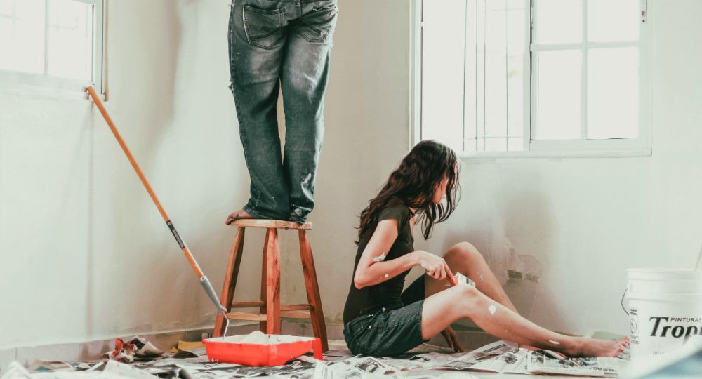 Couple renovating and painting a room