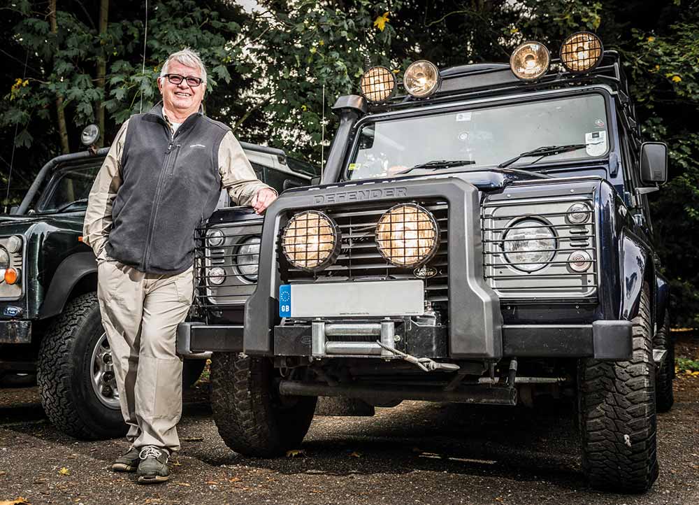 Owner standing next to modified Land Rover Defender
