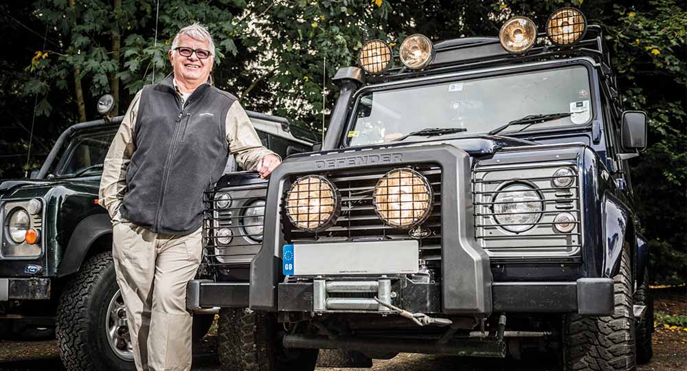 Owner standing next to modified Land Rover Defender