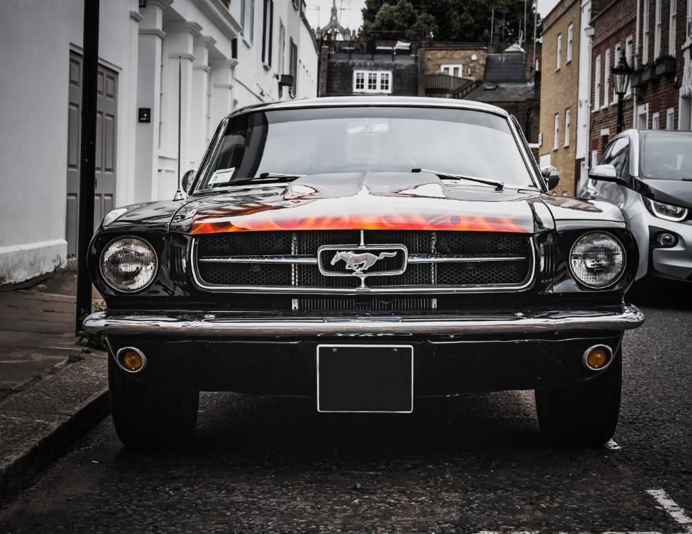 Modified Mustang car parked outside house