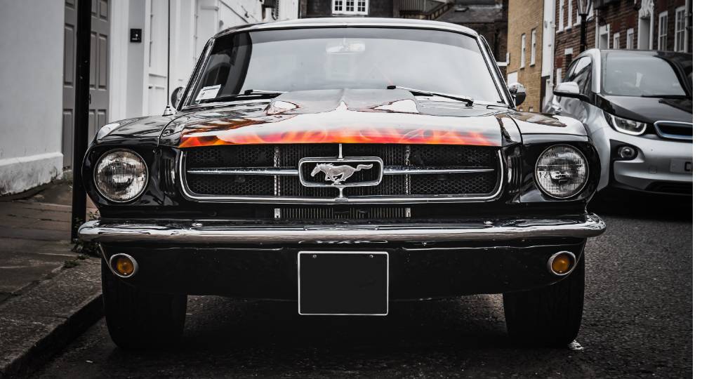 Modified Mustang car parked outside house