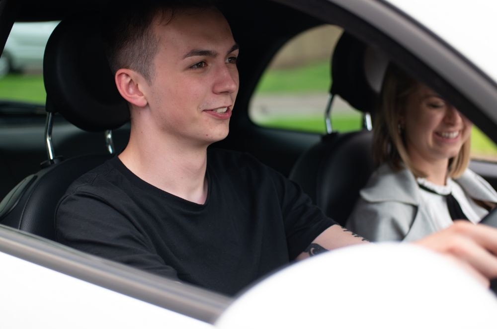 Two young drivers sitting in their car