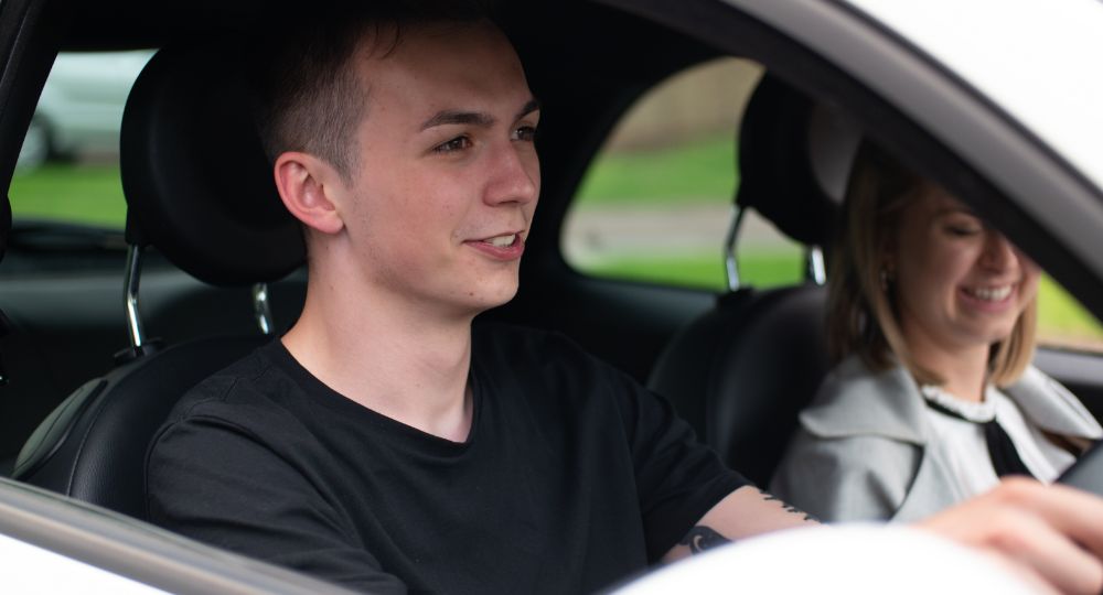 Two young drivers sitting in their car