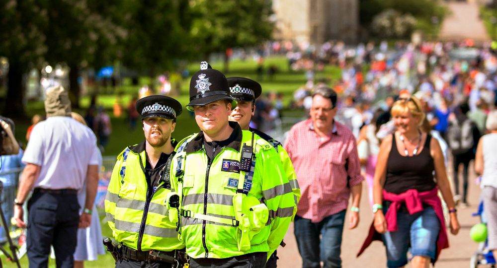 Police patrolling the street on a sunny day