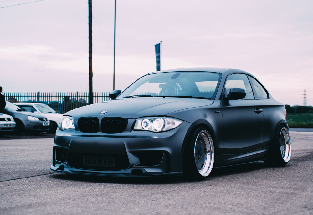 Modified car with low suspension on a cloudy day