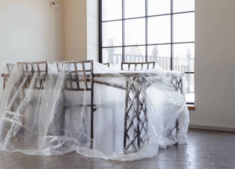 Table and chairs with plastic covering