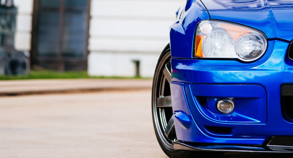 Blue Subaru parked outside a building