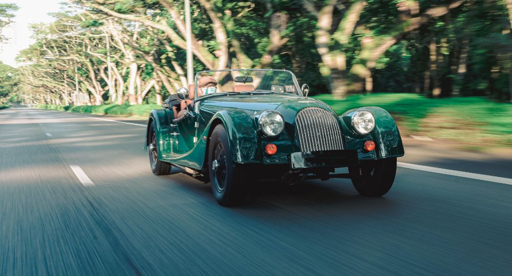 Classic car driving down the road