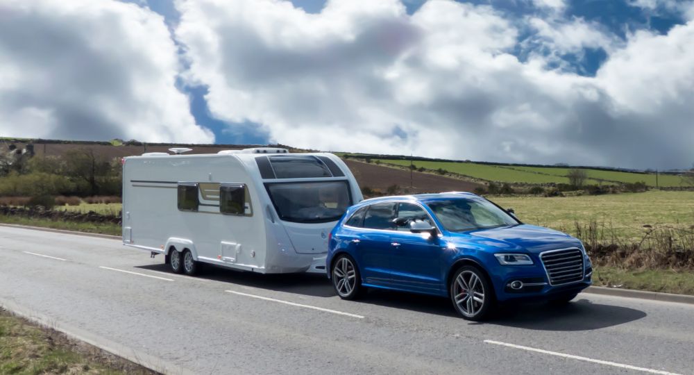 Blue Audi towing a caravan