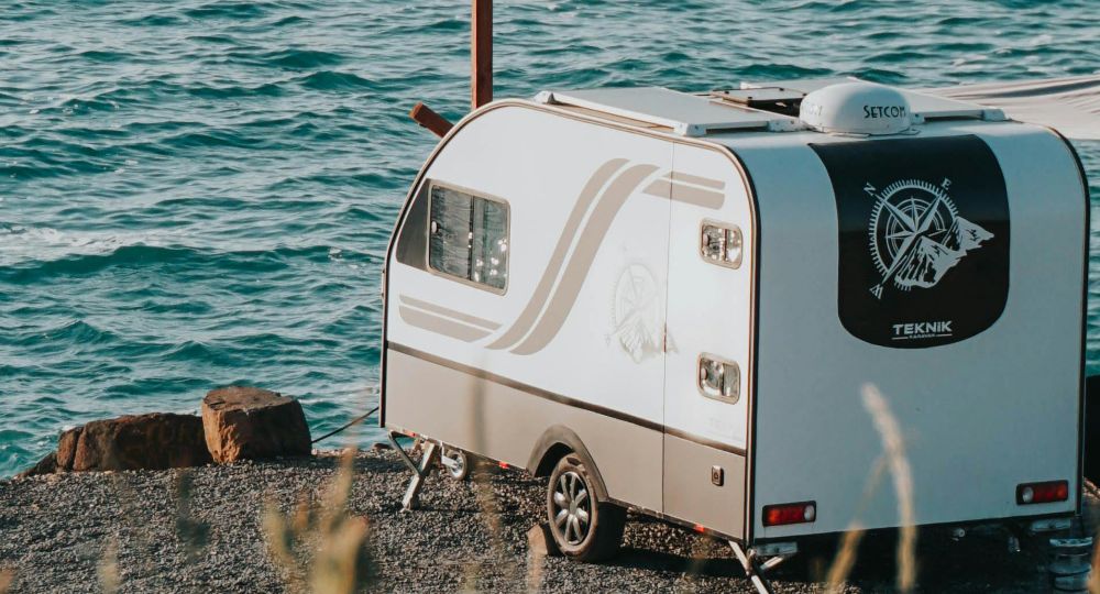 Small caravan parked next to the sea