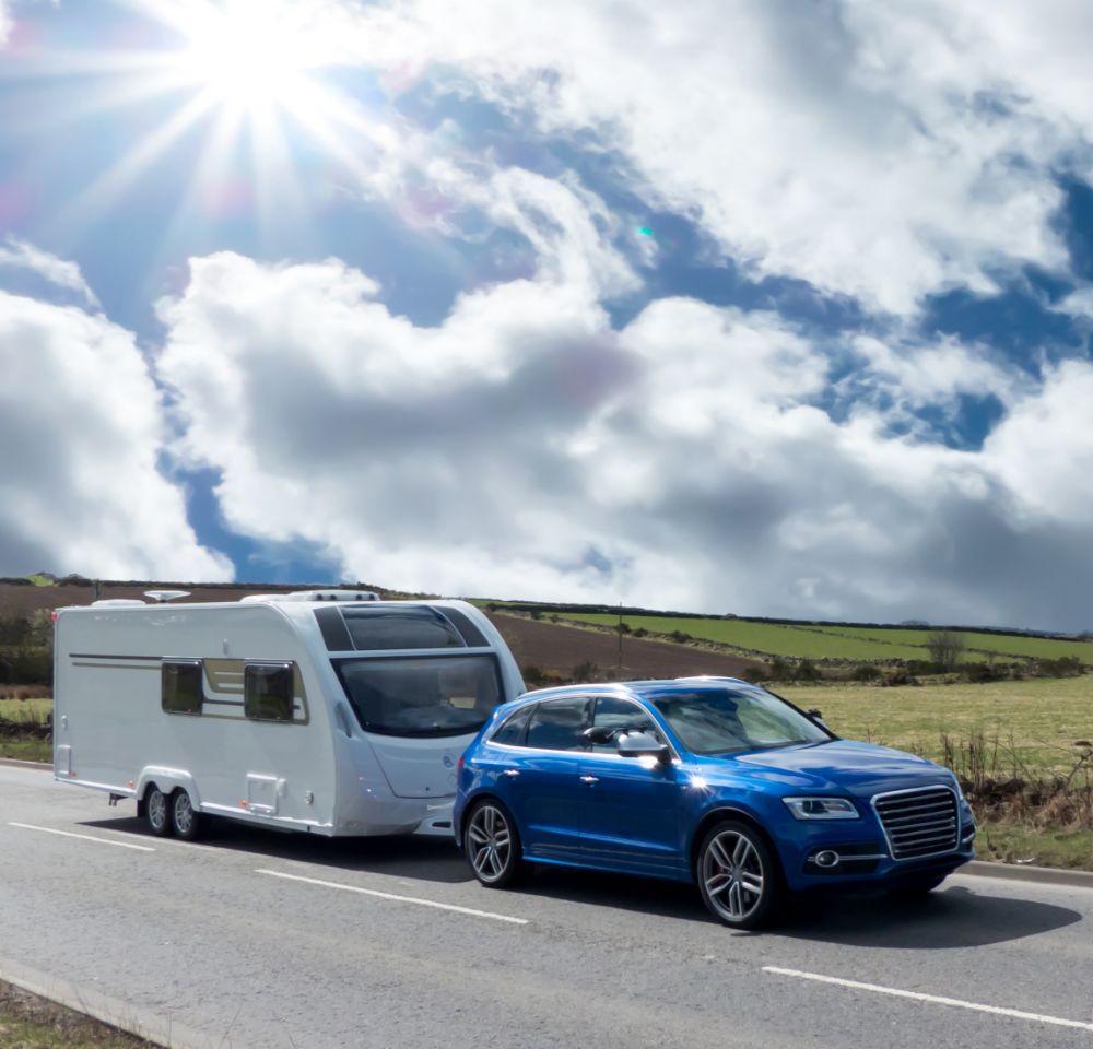 Blue Audi towing a caravan