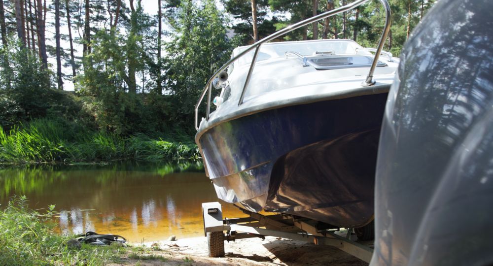 Boat on a trailer being transported by car