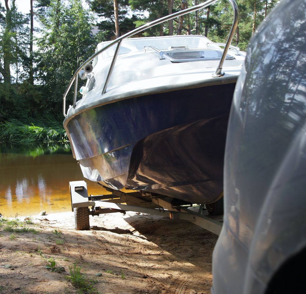 Boat on a trailer being transported by car