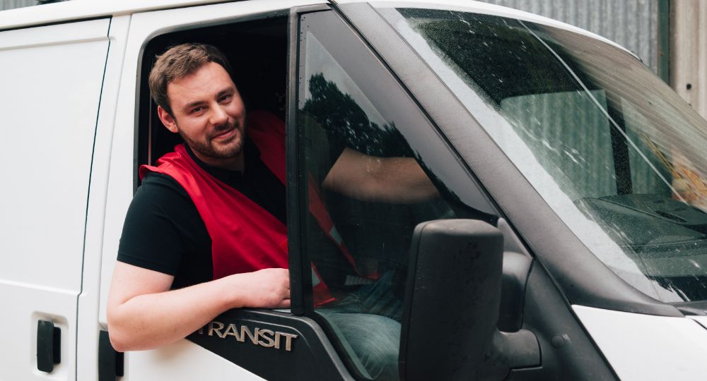 Person leaning out of van