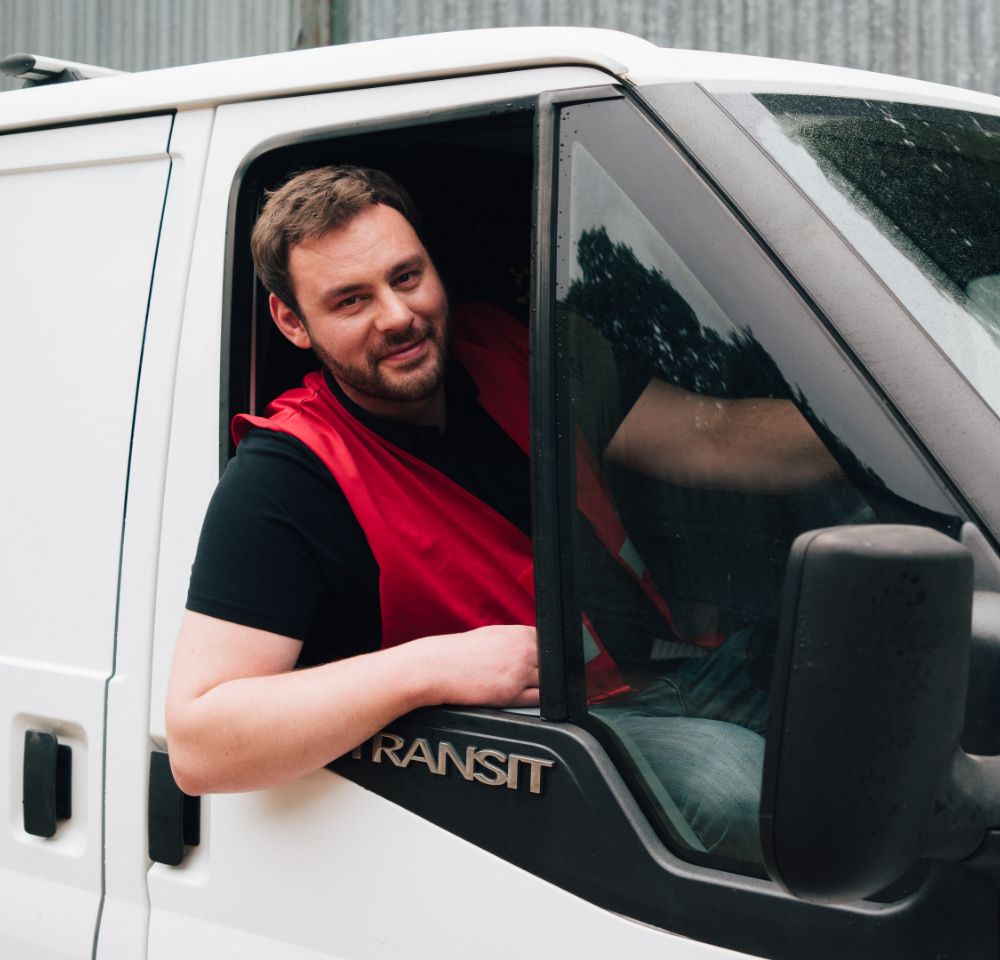 Person leaning out of van