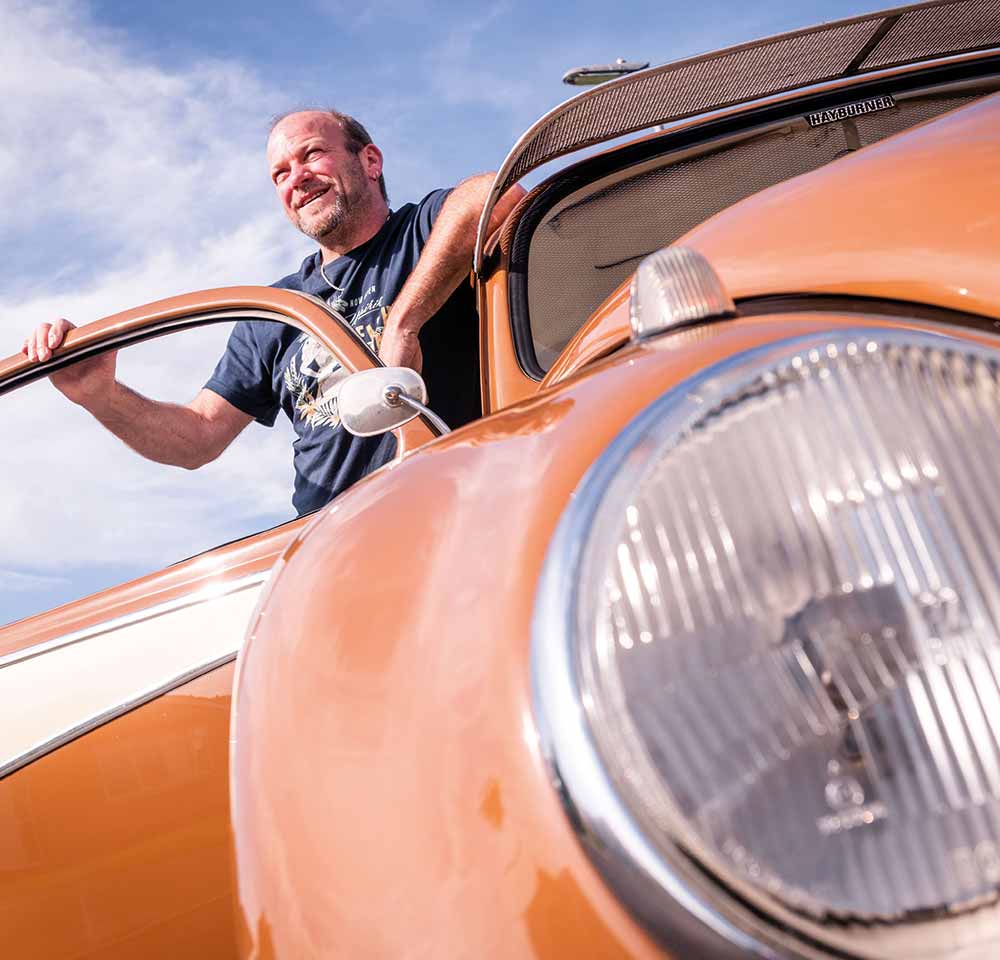 Man standing next to his Beetle
