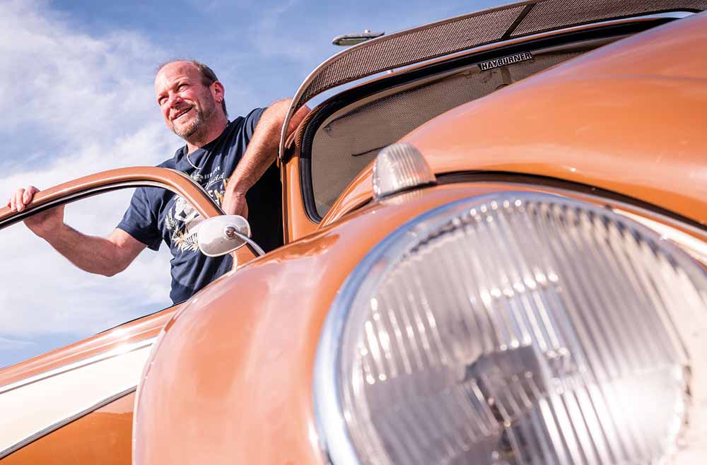 Man standing next to his Beetle